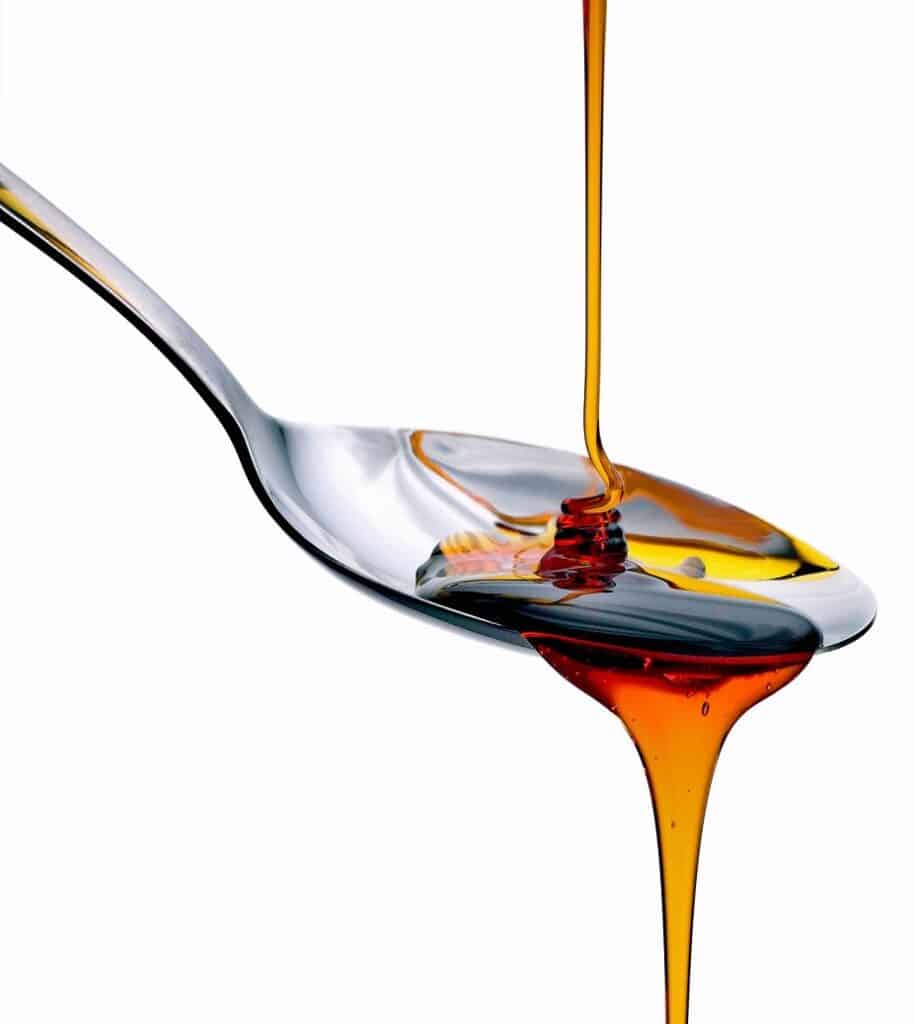maple syrup being drizzled onto a spoon